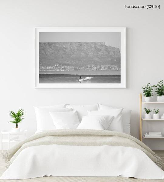 Surfer in black and white beneath Table Mountain