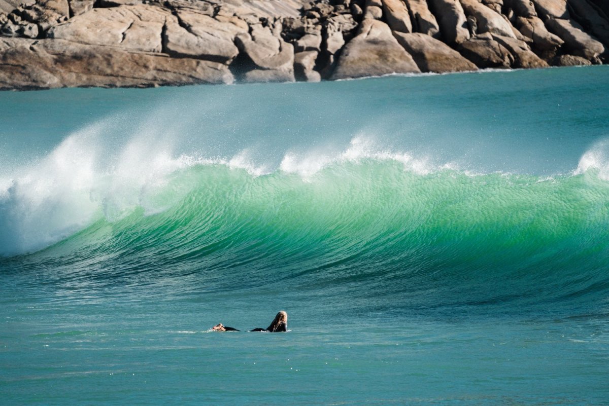 Girl surfing with wave