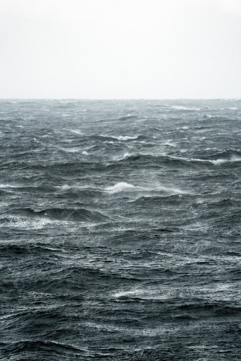 Dramatic and moody image of abstract windy waves in horizon