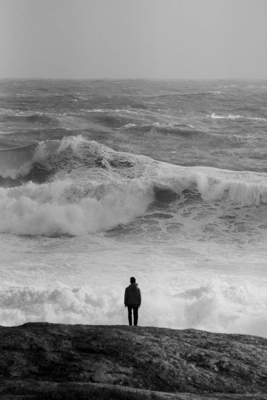 Person watching massive stormy waves photography