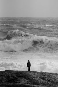Person watching massive stormy waves photography
