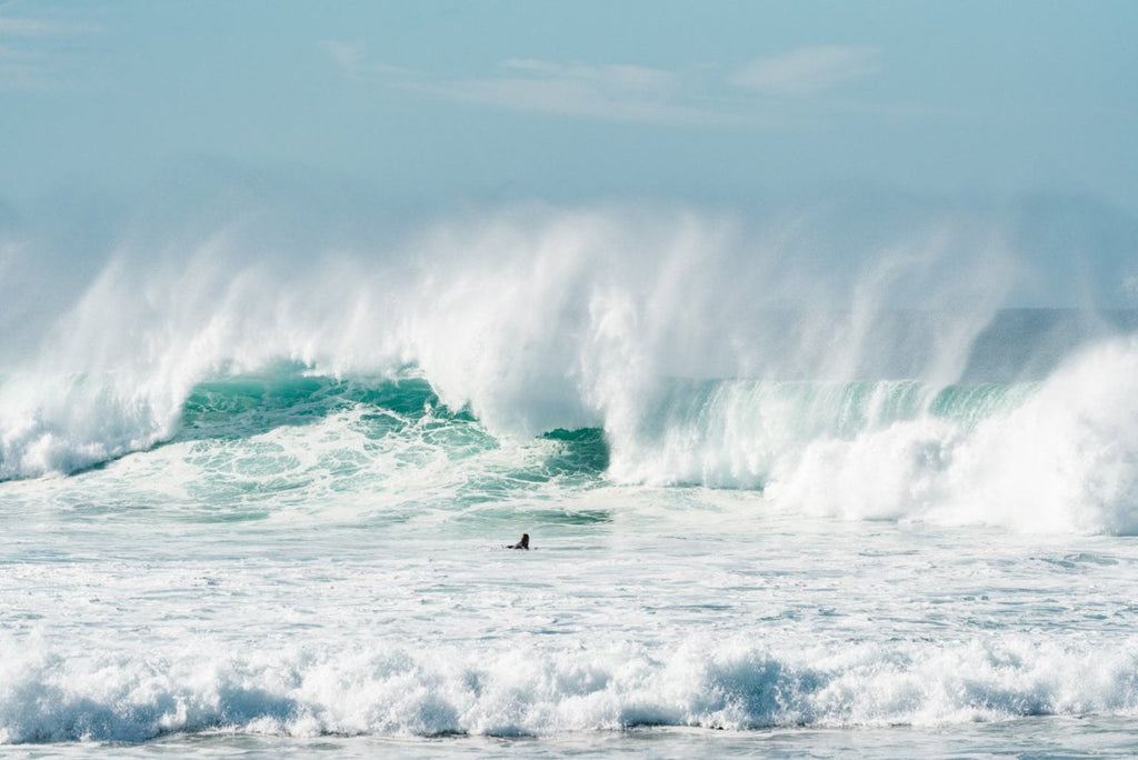 Big blue wave with surfer