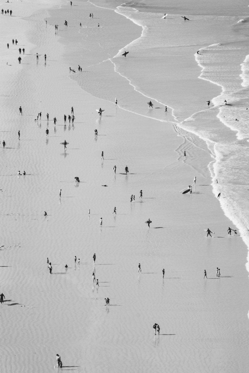 Many people on beach in black and white