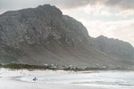 Betty's Bay beach with mountain and surfer