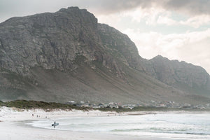 Betty's Bay beach with mountain and surfer
