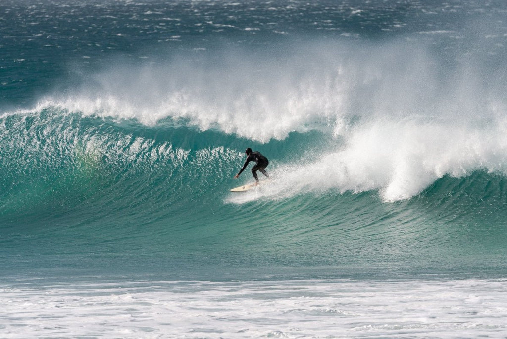 Surfer on blue wave at Jeffrey's Bay