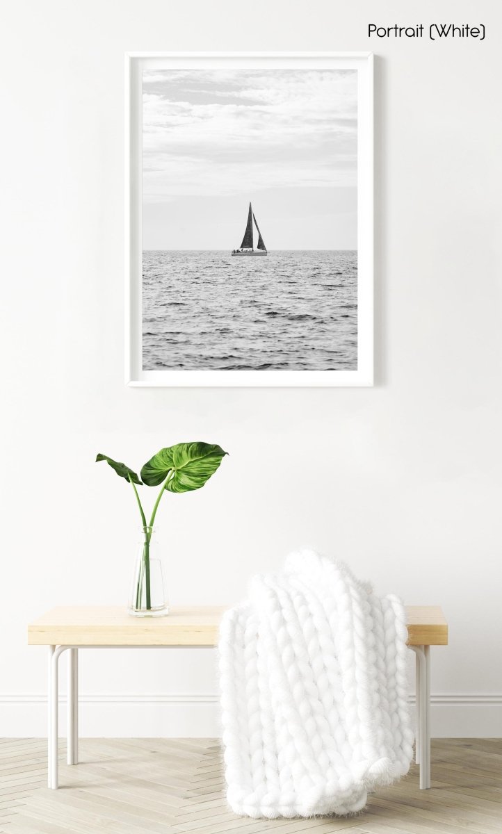 Sailing boat on horizon in black and white