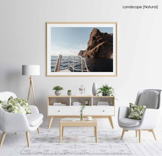 Sunset on a boat overlooking the ocean and mountain with a ladder.