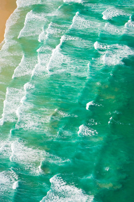 Many waves crashing along Muizenberg beach.