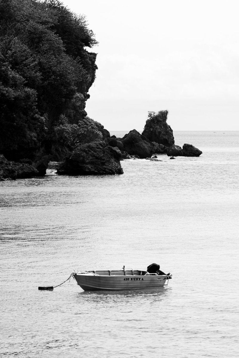 Boat anchored on a calm day in Uluwatu, Bali