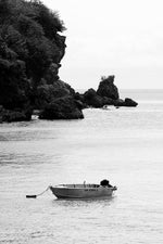 Boat anchored on a calm day in Uluwatu, Bali